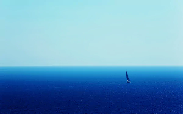 A serene 4K Ultra HD landscape of a blue ocean with a lone sailboat gliding across calm sea waters under a clear sky.