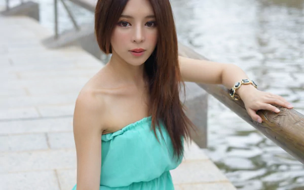 Portrait of Taiwanese model Julie Chang wearing a green dress and bracelet, posing by water, captured in 4K Ultra HD for a PC desktop wallpaper.
