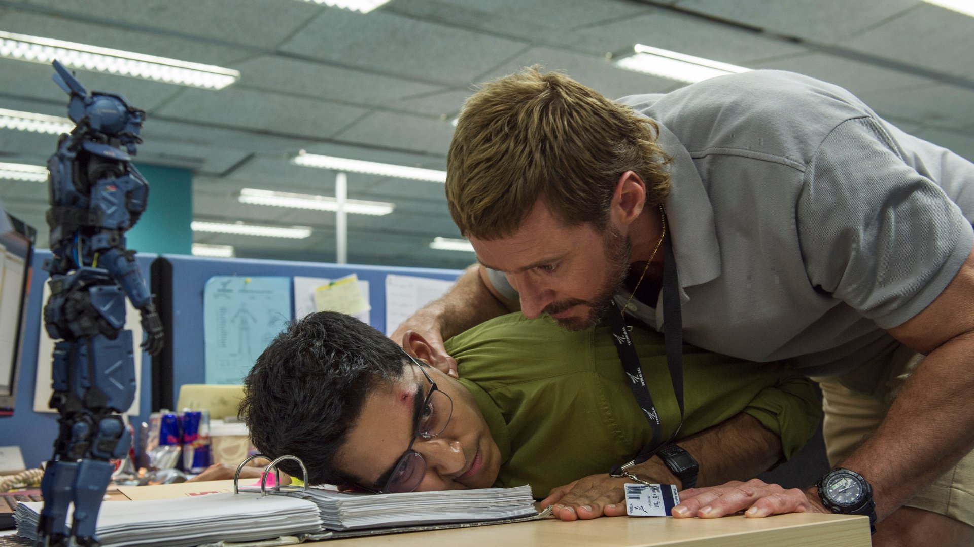 Scene from the movie Chappie featuring Dev Patel, Deon Wilson, Hugh Jackman, and Vincent Moore in a detailed 4K Ultra HD PC desktop wallpaper background.