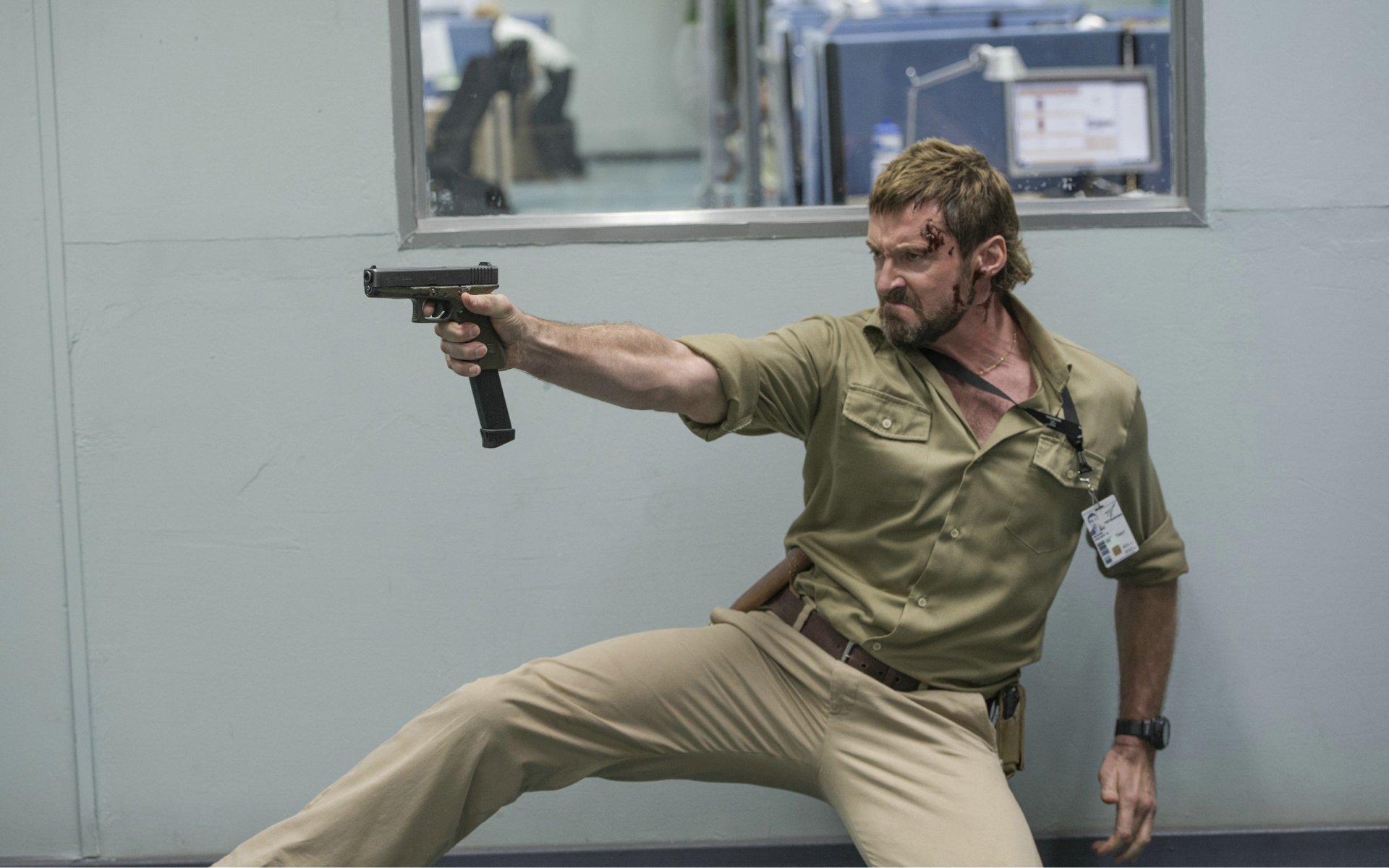 Hugh Jackman as Vincent Moore in an intense action scene from the movie Chappie, captured in this HD PC desktop wallpaper.