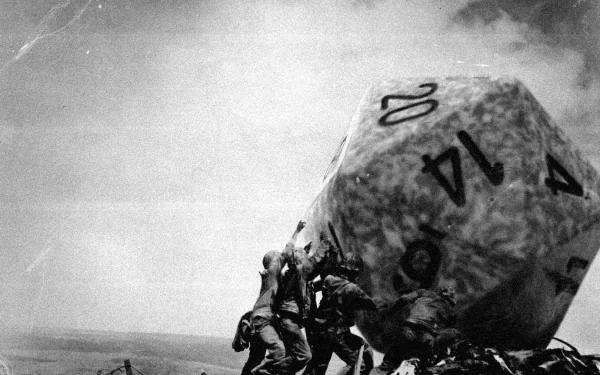A humorous HD wallpaper depicting soldiers on Iwo Jima lifting an oversized dice, blending historical imagery with a playful twist.