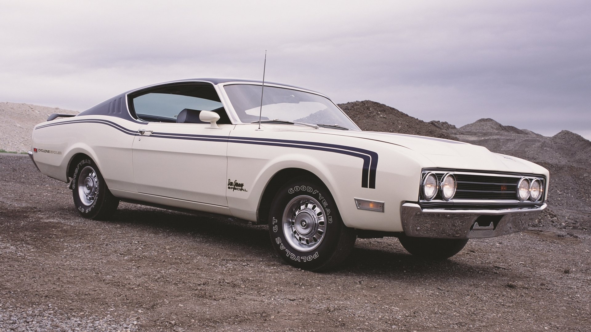 Classic white Mercury Cyclone coupe on gravel with overcast sky, showcased as a 2K Quad HD PC desktop wallpaper/background.