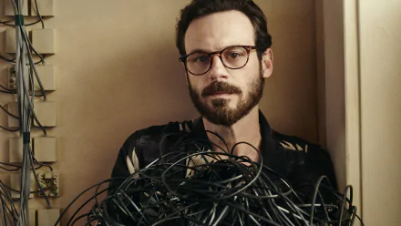 HD wallpaper of Scoot McNairy as Gordon Clark from Halt And Catch Fire, surrounded by tangled cables.