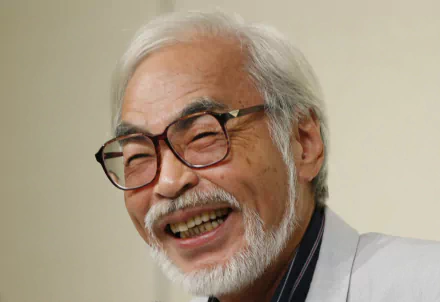 HD desktop wallpaper featuring a joyful individual with white hair and glasses, associated with Hayao Miyazaki.
