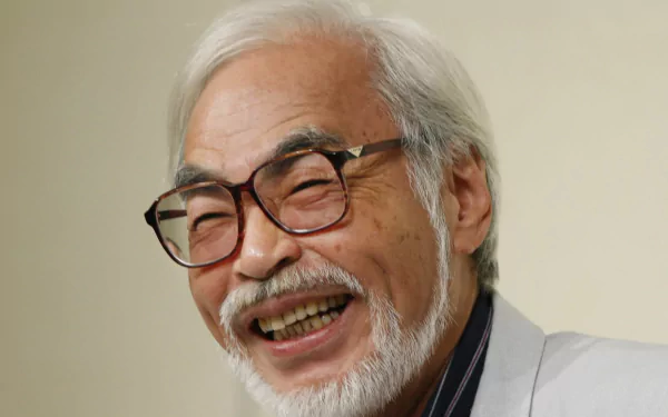 HD desktop wallpaper featuring a joyful individual with white hair and glasses, associated with Hayao Miyazaki.