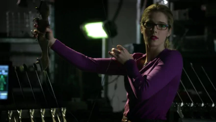 Felicity Smoak, portrayed by Emily Bett Rickards, striking a confident pose with a bow in this HD desktop wallpaper from the TV show Arrow.