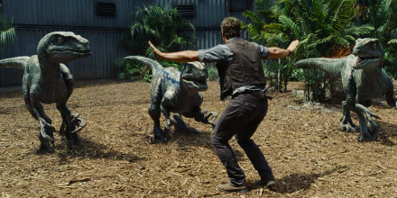 HD desktop wallpaper featuring Chris Pratt interacting with velociraptors from the movie Jurassic World.