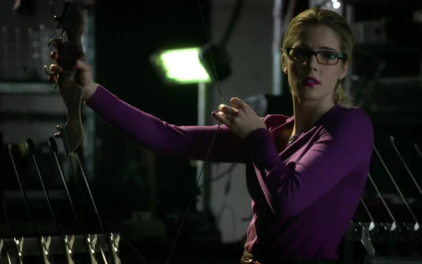 Felicity Smoak, portrayed by Emily Bett Rickards, striking a confident pose with a bow in this HD desktop wallpaper from the TV show Arrow.
