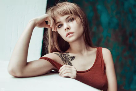 A blonde woman with brown eyes and a tattoo on her shoulder poses thoughtfully. This HD image features model Anastasiya Scheglova and serves as a striking desktop wallpaper and background.
