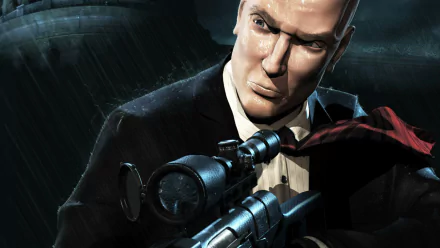 HD PC desktop wallpaper of the video game Hitman: Codename 47 — Agent 47 in a black suit aiming a scoped sniper rifle amid a rain-drenched, shadowy cityscape.