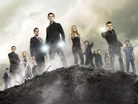 An HD desktop wallpaper featuring characters from the TV show Heroes, standing confidently on a rocky landscape with dramatic lighting and a sense of action and intrigue.