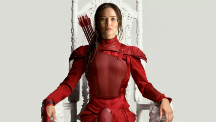 HD desktop wallpaper featuring Jennifer Lawrence as Katniss Everdeen in The Hunger Games: Mockingjay - Part 2, seated in a white throne, wearing a red outfit with arrows on her back.