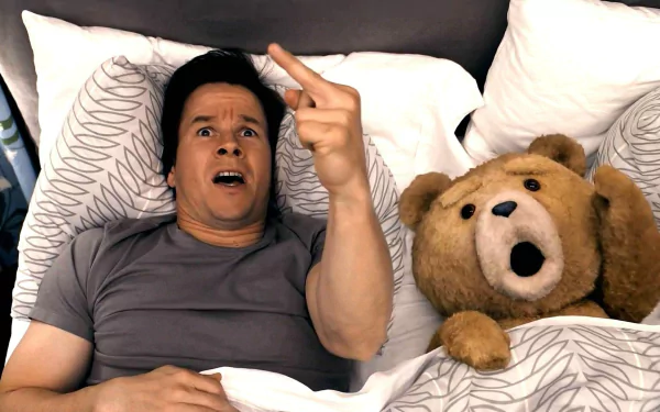 Mark Wahlberg and the movie character Ted lie in bed, both with surprised expressions, in this HD PC desktop wallpaper from the film Ted.