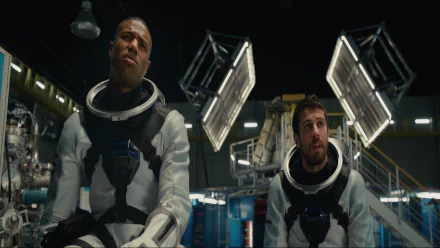 Two astronauts in spacesuits from the movie Fantastic Four (2015) are in a high-tech facility. This HD desktop wallpaper captures a moment from the film.