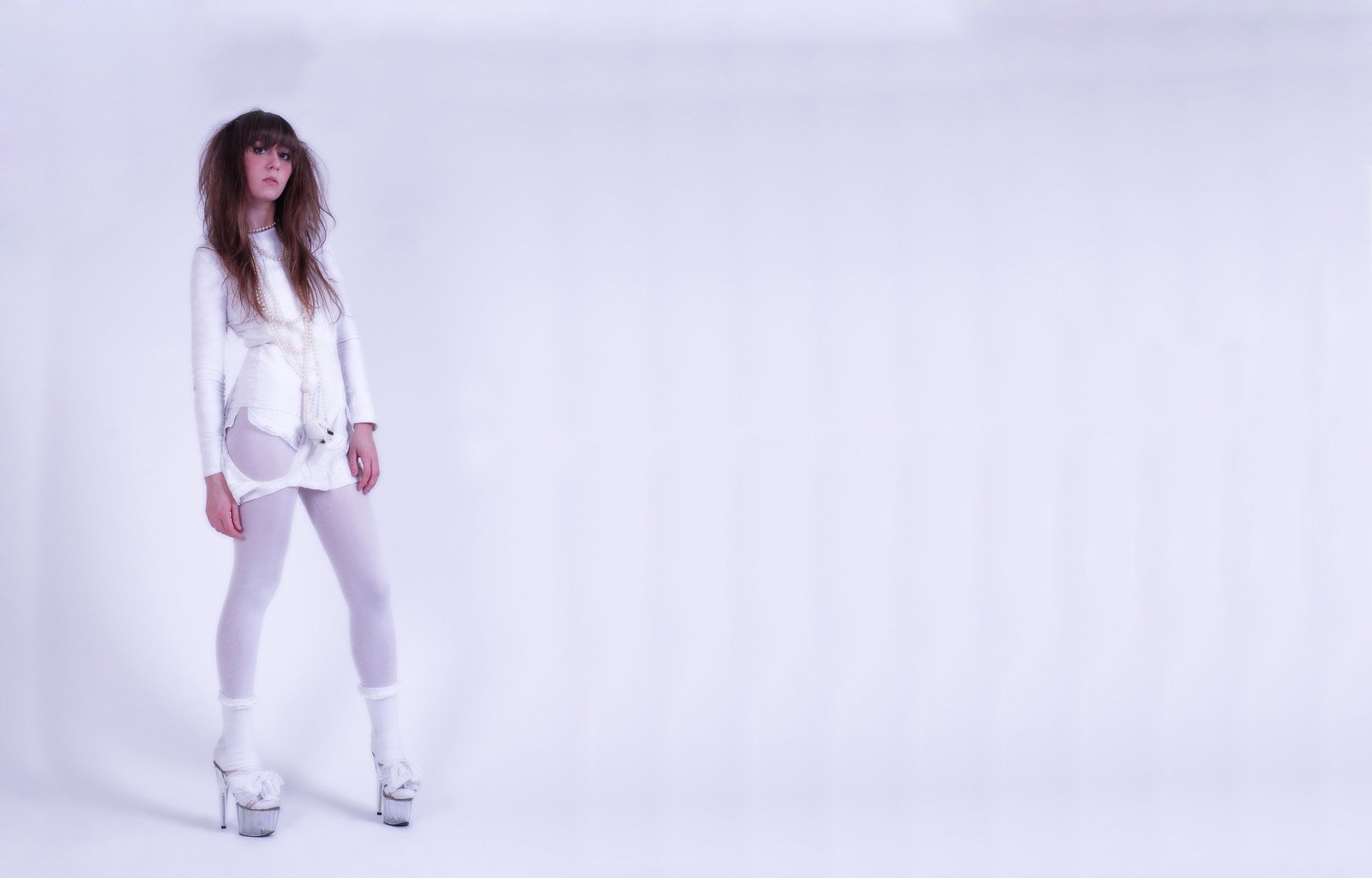 HD PC desktop wallpaper featuring a woman dressed in white against a minimalist light background, creating a clean and modern visual.