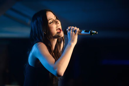 HD PC desktop wallpaper featuring Lena Meyer-Landrut passionately singing into a microphone on stage, highlighting her music career.
