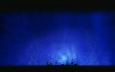 HD desktop wallpaper featuring a surreal, blue fractal pattern with the band Tool performing music in the bottom center, creating a mesmerizing visual effect.