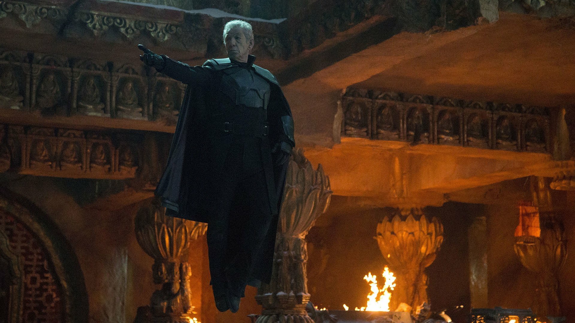 HD PC desktop wallpaper from the movie X-Men: Days of Future Past, featuring a character in a dark coat pointing in a fiery, ancient temple setting.