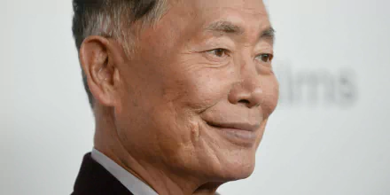 HD desktop wallpaper featuring a close-up of George Takei smiling subtly against a blurred background.