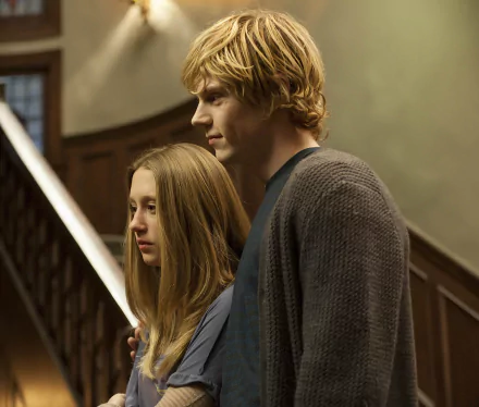 A scene from American Horror Story featuring Taissa Farmiga and Evan Peters, showcasing a tense moment amid a haunting backdrop, perfect for a HD desktop wallpaper.