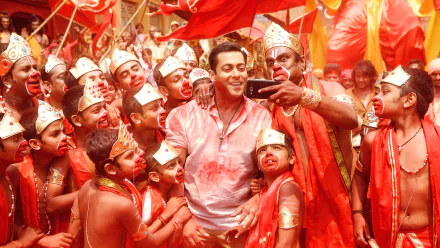 HD PC desktop wallpaper featuring Salman Khan from the movie Bajrangi Bhaijaan, surrounded by joyful children dressed in traditional attire during a festive scene.