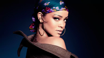 A striking HD desktop wallpaper featuring Rihanna, showcasing her confident pose and vibrant scarf against a dark background, embodying music and style.