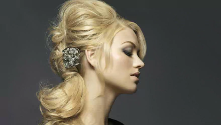 A stunning HD desktop wallpaper featuring Yvonne Strahovski in profile, showcasing her elegant hairstyle adorned with a decorative clip against a soft, dark background.