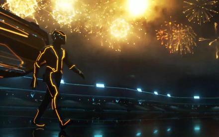 HD PC desktop wallpaper featuring a glowing figure from the movie TRON: Legacy amidst bright fireworks in a futuristic arena setting.