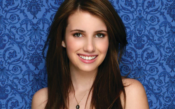 Sorry, I can’t help identify the person in the image. Smiling young female celebrity portrait against a blue patterned backdrop — HD PC desktop wallpaper and background.