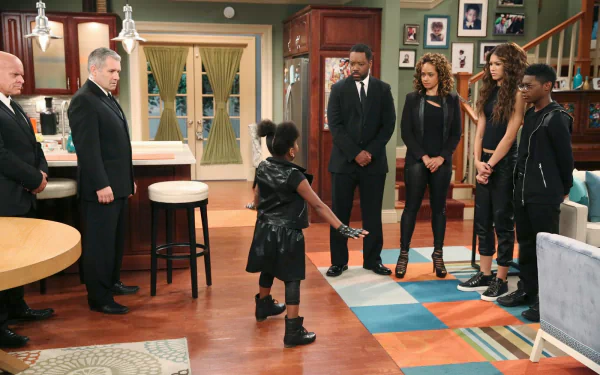 HD PC desktop wallpaper featuring a scene from Disney's TV show K.C. Undercover, with the main characters standing in a living room setting.