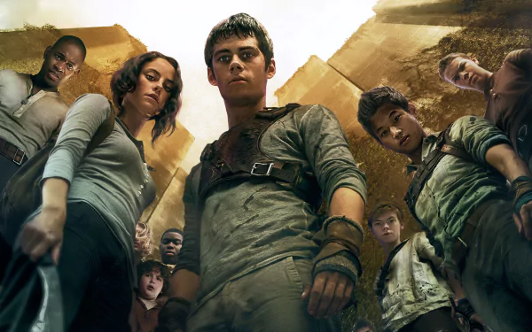 A dramatic scene from The Maze Runner, featuring a group of young characters looking down, surrounded by towering maze walls. This HD image serves as a captivating desktop wallpaper.