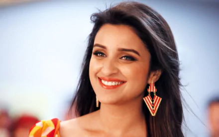 A vibrant HD wallpaper featuring Parineeti Chopra from the movie *Daawat-e-Ishq*, showcasing her smiling with elegant earrings against a colorful background.