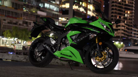 HD desktop wallpaper of a vibrant green Kawasaki Ninja motorcycle, set against a nighttime urban backdrop with modern buildings.