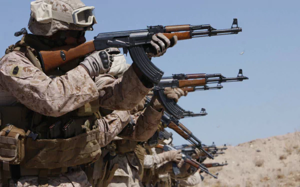HD PC desktop wallpaper showing military soldiers in desert uniforms aiming rifles in formation against a clear blue sky.