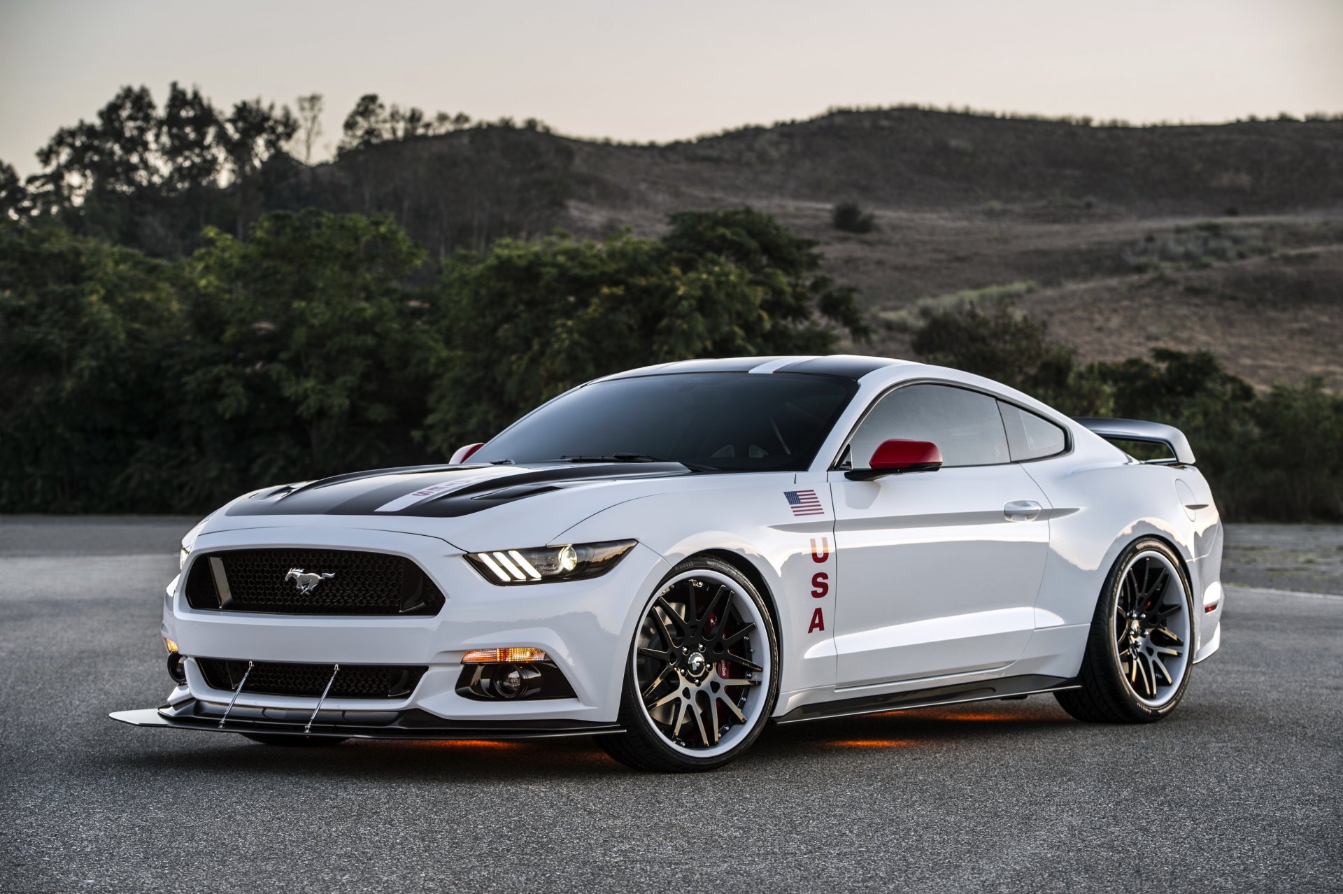 Sleek white Ford Mustang parked on road with scenic hills in the background, showcased in 4K Ultra HD PC desktop wallpaper quality.