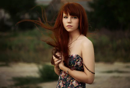 HD desktop wallpaper featuring a red-haired woman model in a floral dress standing outdoors with a blurred natural background.