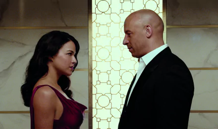 Letty Ortiz and Dominic Toretto share a dramatic moment in a scene from Furious 7, captured in this HD desktop wallpaper. Their intense gaze reflects the film's action-packed essence.