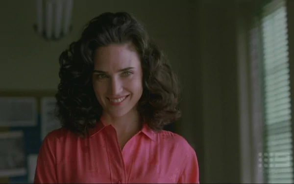 HD desktop wallpaper featuring Jennifer Connelly in a scene from the movie A Beautiful Mind, showcasing her smiling expression and elegant look.