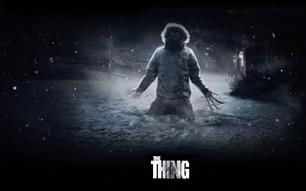 The Thing (2011) 2K Quad HD PC desktop wallpaper/background: lone figure kneeling in snowy Antarctic night, backlit glow and clawed hands, film title centered at bottom.