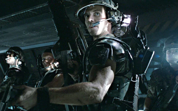 HD PC desktop wallpaper featuring intense soldiers from the movie Alien, capturing a tense sci-fi atmosphere with dark, industrial lighting and futuristic gear.