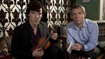 A high-definition desktop wallpaper featuring characters from the TV show Sherlock, showcasing the iconic detectives in a cozy setting, with one holding a violin and the other a notepad.