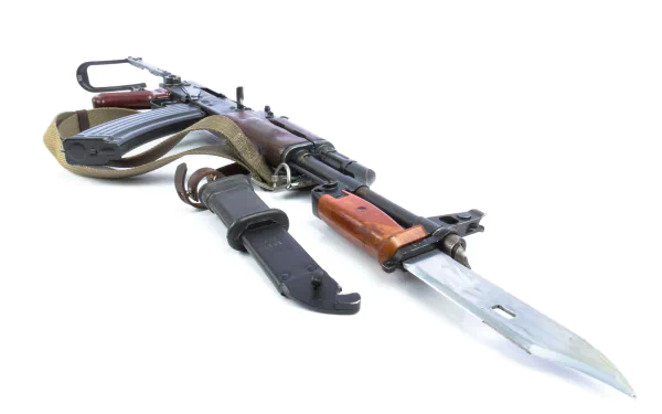 A high-definition desktop wallpaper featuring an AK-47 rifle with a bayonet attached, showcasing intricate details of the weapon's design.