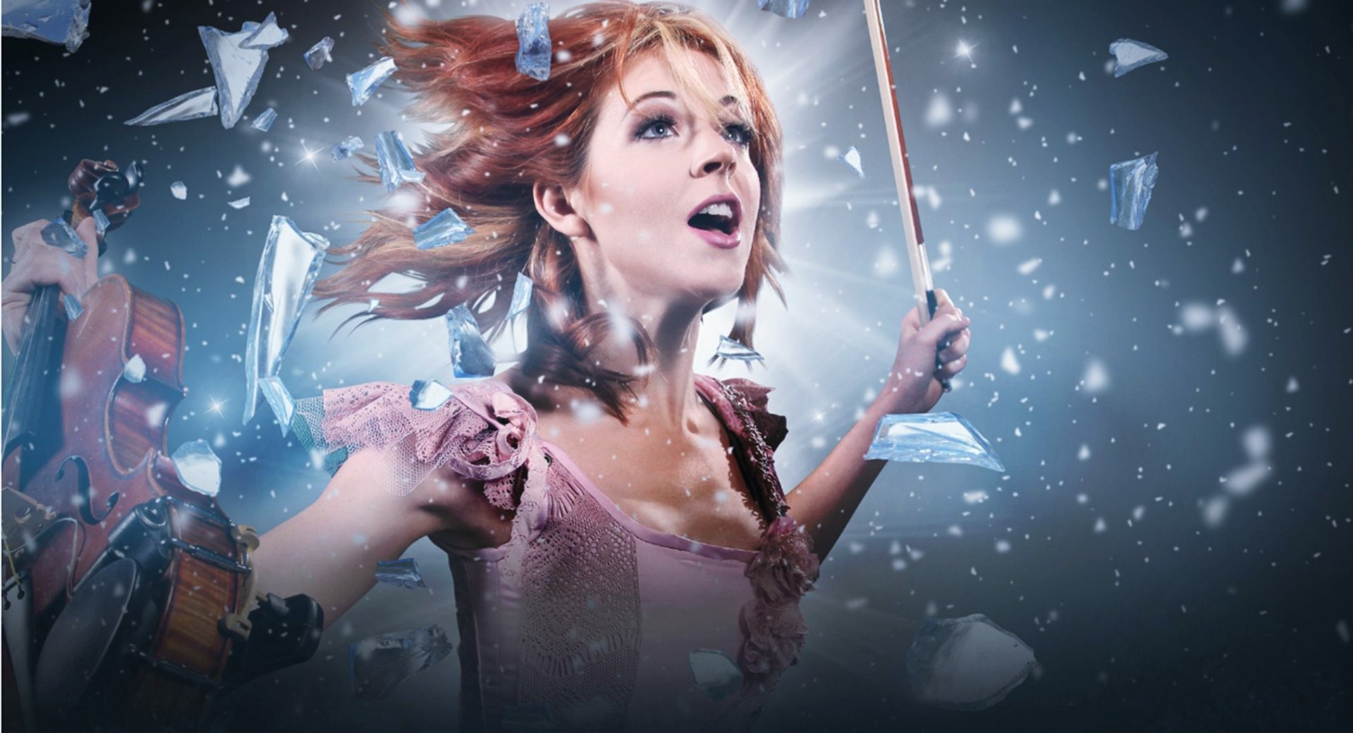 HD PC desktop wallpaper featuring musician Lindsey Stirling playing violin amidst dynamic shards and glowing effects.