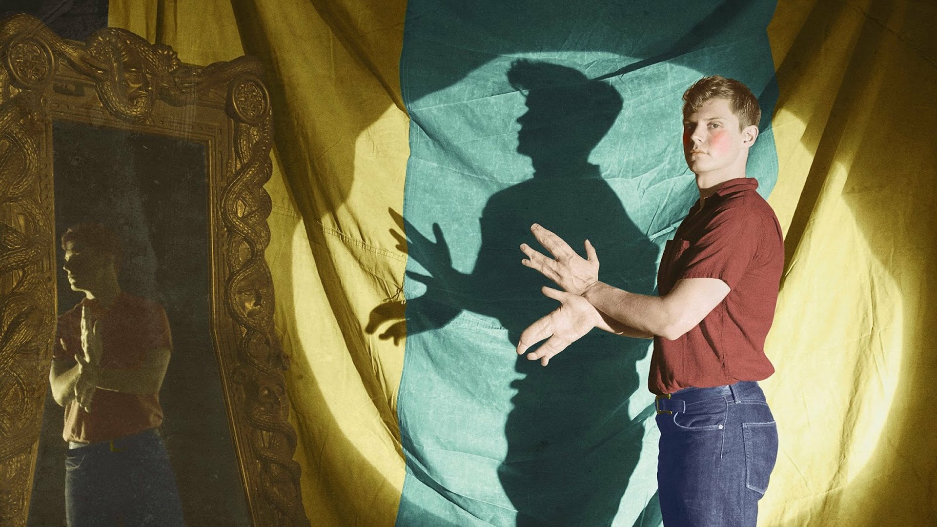 HD PC desktop wallpaper: American Horror Story TV show scene — person in red shirt casts monstrous shadow hands on yellow-green drape beside an ornate mirror.