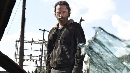 Rick Grimes, portrayed by Andrew Lincoln, stands amidst a post-apocalyptic landscape in this HD wallpaper from the TV show The Walking Dead.