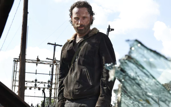 Rick Grimes, portrayed by Andrew Lincoln, stands amidst a post-apocalyptic landscape in this HD wallpaper from the TV show The Walking Dead.