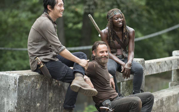 A vibrant HD wallpaper featuring Michonne, Rick Grimes, and Glenn Rhee from The Walking Dead, showcasing their camaraderie amid the apocalyptic landscape.