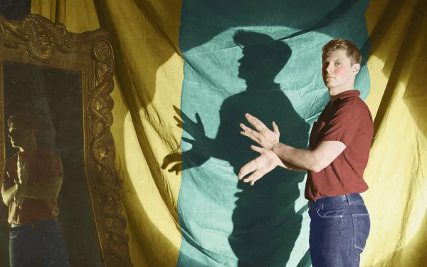 HD PC desktop wallpaper: American Horror Story TV show scene — person in red shirt casts monstrous shadow hands on yellow-green drape beside an ornate mirror.