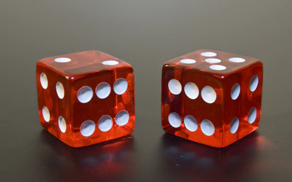 4K Ultra HD PC desktop wallpaper and background showing two red translucent dice with white pips resting on a reflective dark surface.