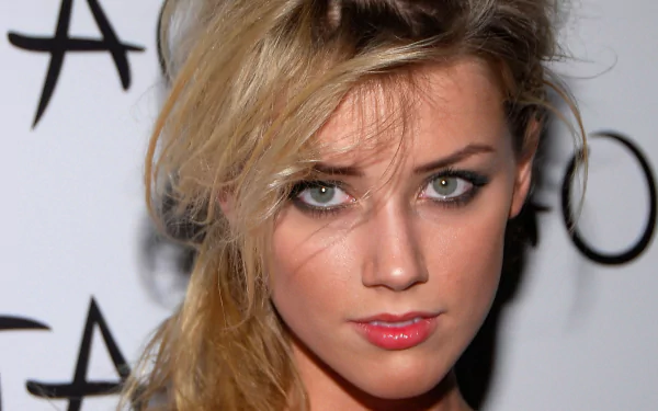 A striking HD wallpaper featuring celebrity Amber Heard, showcasing her captivating gaze and defined features against a simple background.